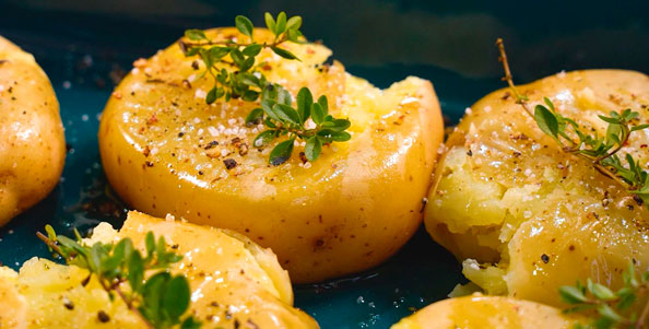 Batatas ao murro, temperada dom sal, pimenta-do-reino e tomilho fresco